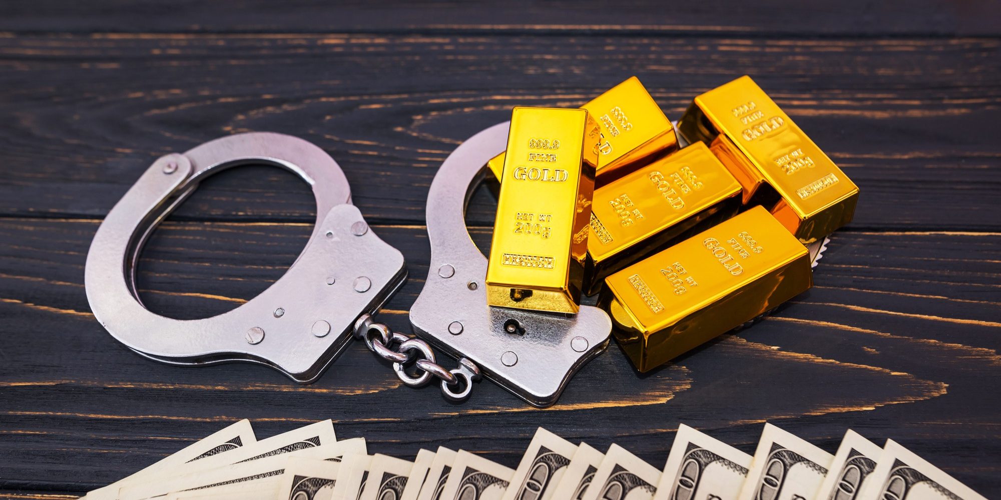 bribe-concept-gold-bars-handcuff-dollar-bills