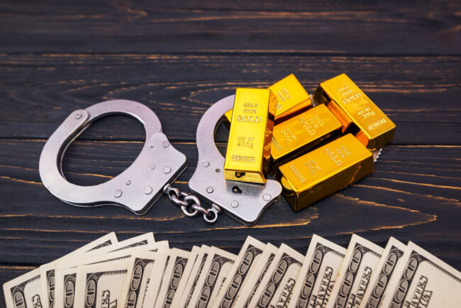 bribe-concept-gold-bars-handcuff-dollar-bills